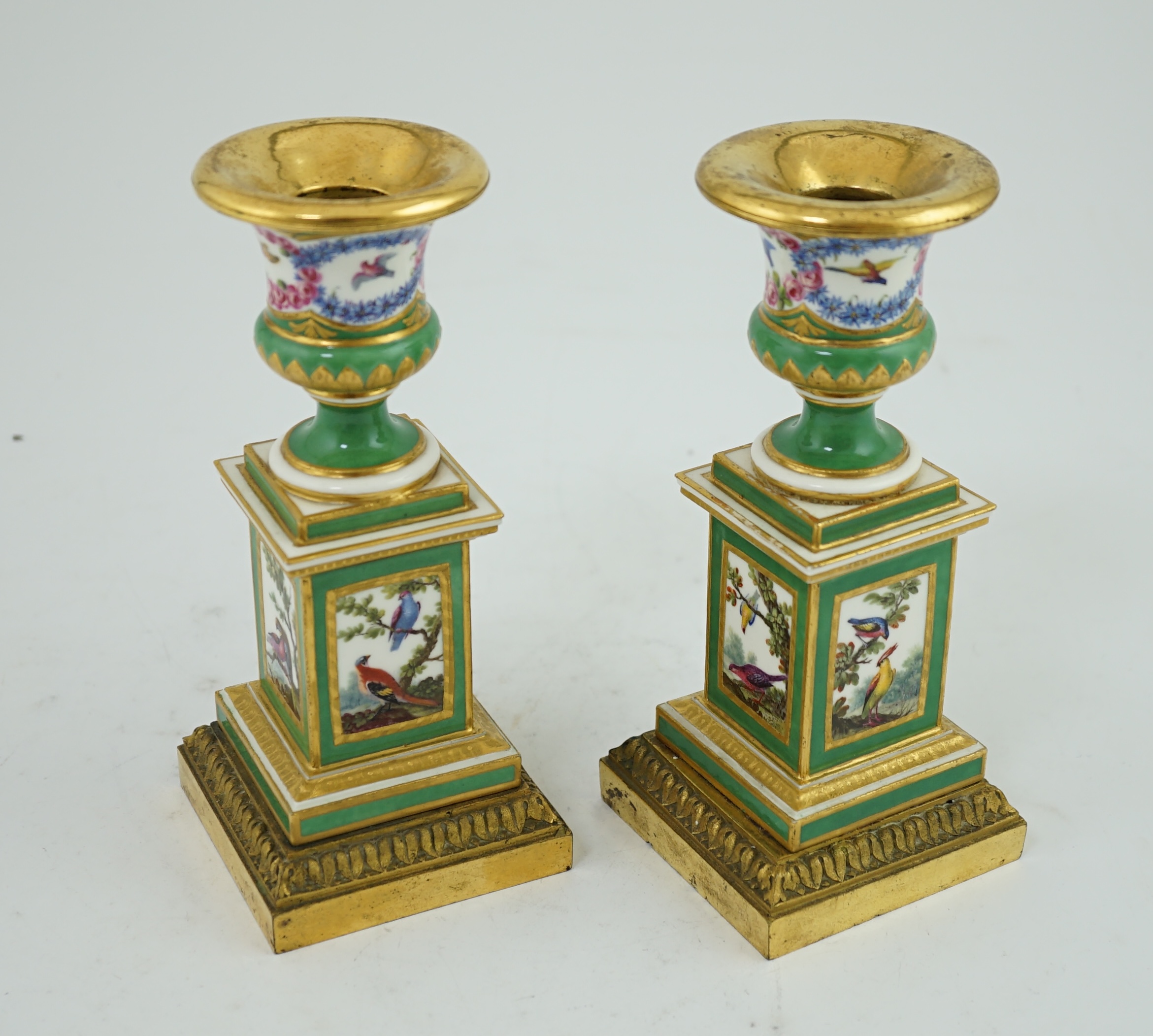 A pair of late 18th century Sevres ormolu mounted porcelain candlesticks, in the manner of Chappuis L'Aine